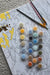 Acrylic paint pots and brushes used for paint by numbers artwork